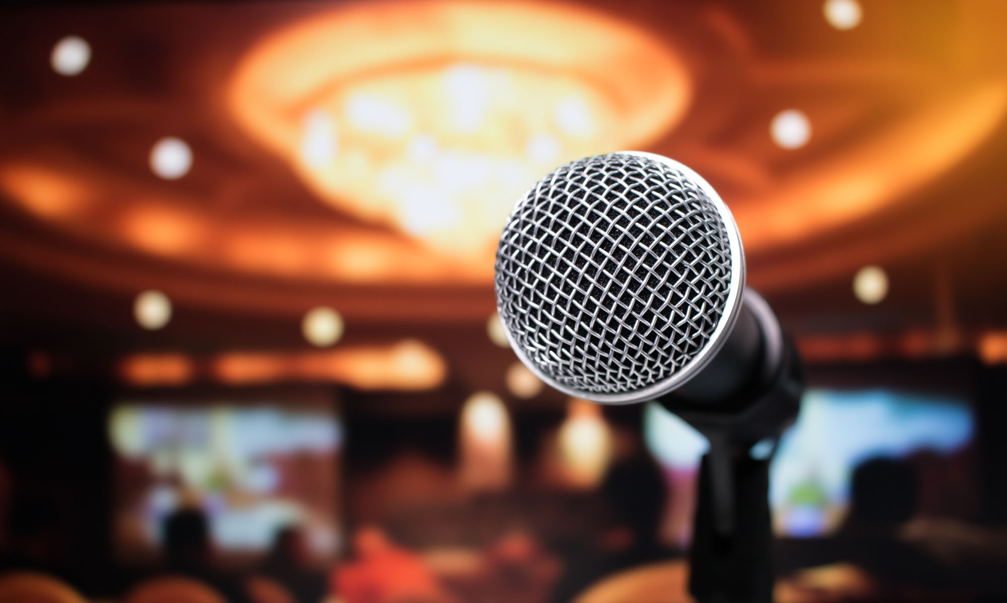 Microphone on abstract blurred of speech in seminar room or speaking conference hall light, Event Background